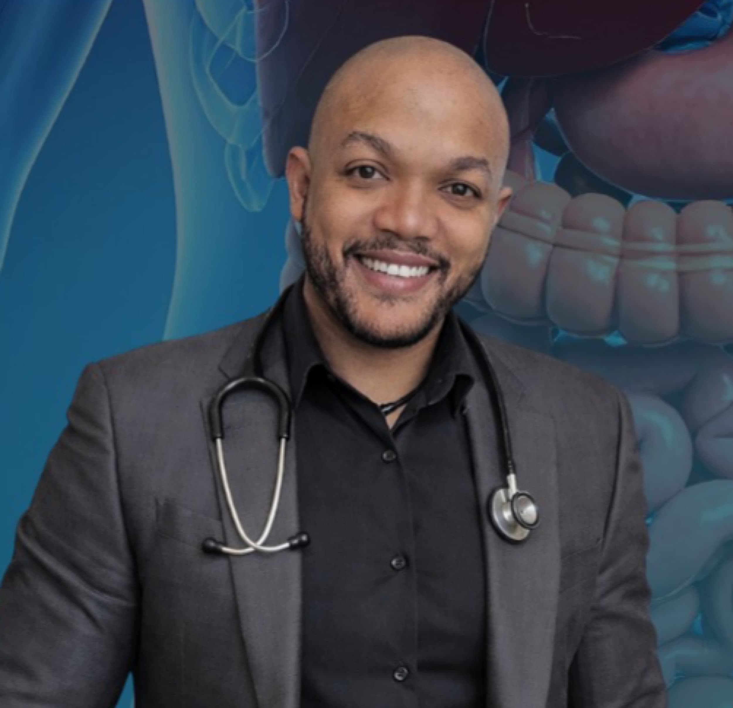 Smiling bald man wearing a grey blazer and stethoscope against a blue anatomical digestive background.